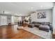 Open-concept living space with hardwood floors, ample seating, and a seamless transition to the modern kitchen at 596 Frank Kirk Nw Rd, Kennesaw, GA 30152