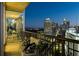 Relax on this beautiful balcony with chairs, cushions, and amazing views of the city skyline at night at 1080 Peachtree Ne St # 2011, Atlanta, GA 30309