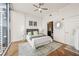 Bright bedroom featuring a ceiling fan, stylish decor, and an ensuite bathroom at 1080 Peachtree Ne St # 2011, Atlanta, GA 30309