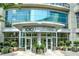 Exterior shot of a modern building entrance with manicured landscaping and clear signage at 1080 Peachtree Ne St # 2011, Atlanta, GA 30309