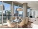 Bright dining area with city views, designer lighting and glass-top table at 1080 Peachtree Ne St # 2011, Atlanta, GA 30309