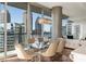 Dining area with modern chandelier, glass table and expansive city views at 1080 Peachtree Ne St # 2011, Atlanta, GA 30309