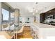 Open dining and kitchen area with modern lighting, glass table and city views at 1080 Peachtree Ne St # 2011, Atlanta, GA 30309