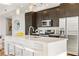 Modern kitchen with stainless steel appliances, bar seating, and marble countertops at 1080 Peachtree Ne St # 2011, Atlanta, GA 30309