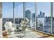 Living area with comfortable seating by expansive windows showcasing the city skyline, perfect for relaxing at 1080 Peachtree Ne St # 2011, Atlanta, GA 30309