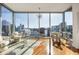 Bright living room featuring floor-to-ceiling windows with stunning city views and hardwood floors at 1080 Peachtree Ne St # 2011, Atlanta, GA 30309