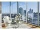 Bright sitting area features floor-to-ceiling windows with city views, hardwood floors, modern furniture, and decor at 1080 Peachtree Ne St # 2011, Atlanta, GA 30309