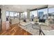 Open-concept living space with abundant natural light, a modern kitchen, and comfortable seating arrangements at 1080 Peachtree Ne St # 2011, Atlanta, GA 30309