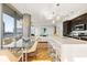 Bright open-concept living space featuring floor-to-ceiling windows and a modern kitchen with a waterfall island at 1080 Peachtree Ne St # 2011, Atlanta, GA 30309