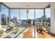 Bright sitting area features floor-to-ceiling windows with city views, hardwood floors, modern furniture, and decor at 1080 Peachtree Ne St # 2011, Atlanta, GA 30309