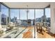 Bright living room featuring floor-to-ceiling windows with a stunning city view and hardwood floors at 1080 Peachtree Ne St # 2011, Atlanta, GA 30309