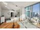 Sunlit main bedroom with hardwood floors, floor-to-ceiling windows and a sitting area at 1080 Peachtree Ne St # 2011, Atlanta, GA 30309