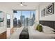 Bright bedroom featuring hardwood floors and a view of the city skyline at 1080 Peachtree Ne St # 2011, Atlanta, GA 30309