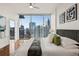 Bedroom featuring large windows showing city views and a plush bed for relaxation at 1080 Peachtree Ne St # 2011, Atlanta, GA 30309