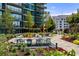 Beautifully landscaped outdoor patio with dining table, chairs and green plantings at 1080 Peachtree Ne St # 2011, Atlanta, GA 30309