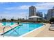 Rooftop pool with comfortable lounge chairs and umbrellas overlooking the city skyline at 1080 Peachtree Ne St # 2011, Atlanta, GA 30309