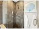 This walk-in shower features a tile surround, glass door, and bench for a luxurious experience at 1080 Peachtree Ne St # 2011, Atlanta, GA 30309