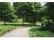 Picturesque walking path winding through a lush park with mature trees and manicured lawns at 1080 Peachtree Ne St # 2011, Atlanta, GA 30309