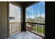 View from the covered balcony showing landscaping, green space, and neighboring properties at 115 Alcovy Ter, Alpharetta, GA 30009