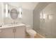 Modern bathroom featuring a sleek vanity, contemporary lighting, and a glass-enclosed shower at 115 Alcovy Ter, Alpharetta, GA 30009