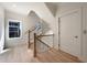 Hallway features a staircase with dark iron railings, wood treads, and a window for natural light at 115 Alcovy Ter, Alpharetta, GA 30009