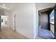 Bright hallway leads to an outdoor covered patio with natural light streaming in through a doorway at 115 Alcovy Ter, Alpharetta, GA 30009