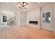 Living room with a modern fireplace, large windows, and hardwood flooring at 115 Alcovy Ter, Alpharetta, GA 30009