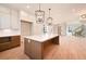 Bright living room featuring modern fireplace, hardwood floors, and staircase access at 115 Alcovy Ter, Alpharetta, GA 30009