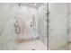 Modern shower features a glass door, sleek fixtures, built-in shelves, and stylish marble tile at 115 Alcovy Ter, Alpharetta, GA 30009