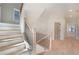 Bright staircase with wood railing and black iron spindles leading to the second floor hallway at 115 Alcovy Ter, Alpharetta, GA 30009