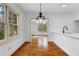 Dining area featuring hardwood floors, modern lighting, and smooth transition to the kitchen at 1179 Aleamo Dr, Marietta, GA 30062