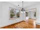 Cozy dining area featuring hardwood floors, modern lighting, and a view to the outside at 1179 Aleamo Dr, Marietta, GA 30062