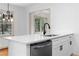 Kitchen island featuring a stainless steel dishwasher, white cabinets, quartz countertops, and a view to the outside at 1179 Aleamo Dr, Marietta, GA 30062