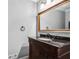 Elegant bathroom featuring a granite countertop, wooden vanity, and a large, framed mirror at 4203 Deerbrook Sw Way, Lilburn, GA 30047