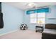 Light blue bedroom with natural light, a sofa, and a fun soccer ball chair for a playful and inviting atmosphere at 4203 Deerbrook Sw Way, Lilburn, GA 30047