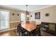 Charming dining room featuring a wood table, chandelier, and ample natural light from the window at 4203 Deerbrook Sw Way, Lilburn, GA 30047