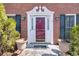 Elegant entryway with decorative trim, sconces, and potted plants leading to the front door at 4203 Deerbrook Sw Way, Lilburn, GA 30047