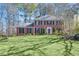 Charming brick home with manicured lawn, black shutters, and red front door provides classic curb appeal at 4203 Deerbrook Sw Way, Lilburn, GA 30047