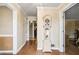 Inviting hallway with hardwood floors, neutral paint, and a charming grandfather clock at 4203 Deerbrook Sw Way, Lilburn, GA 30047