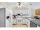 The kitchen features white appliances, white cabinets, and an eat-in area at 4203 Deerbrook Sw Way, Lilburn, GA 30047