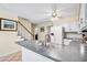 Sunlit kitchen featuring an island with a sink, white cabinets, and a view into the dining room at 4203 Deerbrook Sw Way, Lilburn, GA 30047