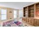 Bright living room featuring built-in wooden bookcase, hardwood floors, and natural light at 4203 Deerbrook Sw Way, Lilburn, GA 30047