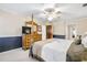 Spacious main bedroom featuring a ceiling fan, a dresser with a mirror, and carpeted floors at 4203 Deerbrook Sw Way, Lilburn, GA 30047