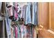 Walk-in closet with hanging racks and shelves filled with organized clothing and accessories at 4203 Deerbrook Sw Way, Lilburn, GA 30047