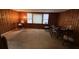 Inviting dining room with classic wood paneling and neutral carpeting, perfect for Gathering meals at 6385 Gordon St, Lithia Springs, GA 30122