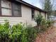 Side view of home with natural landscaping around perimeter at 6385 Gordon St, Lithia Springs, GA 30122