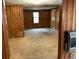 Cozy living room featuring wood paneling, neutral carpet and a bright window for natural light at 6385 Gordon St, Lithia Springs, GA 30122