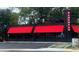 Exterior view of Bankhead featuring large windows and red awnings under a black building at 662 S Grand Nw Ave, Atlanta, GA 30318