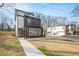 Modern two-story home boasting a unique exterior, balcony, and well-manicured front yard at 662 S Grand Nw Ave, Atlanta, GA 30318