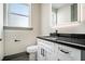 Powder room features a modern vanity with black countertop and black faucet at 662 S Grand Nw Ave, Atlanta, GA 30318